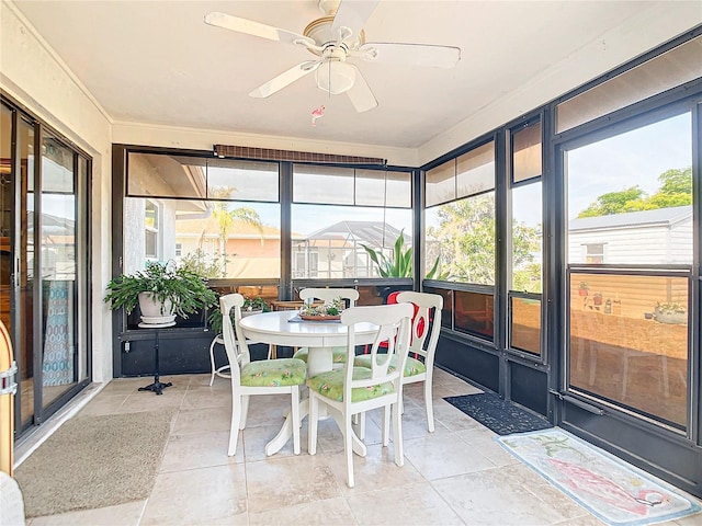 sunroom featuring ceiling fan