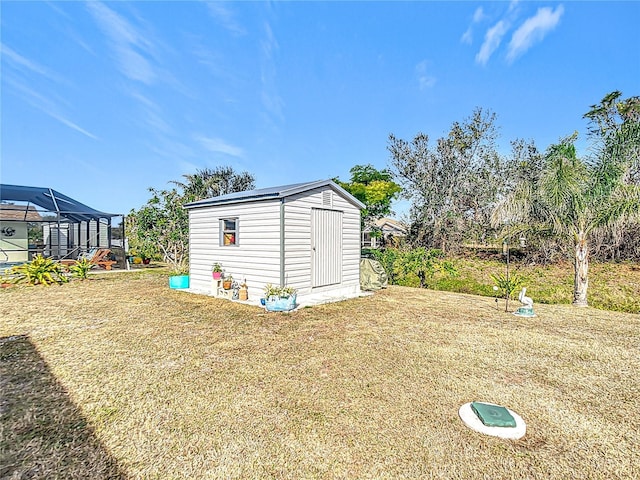 view of yard with a lanai and a shed