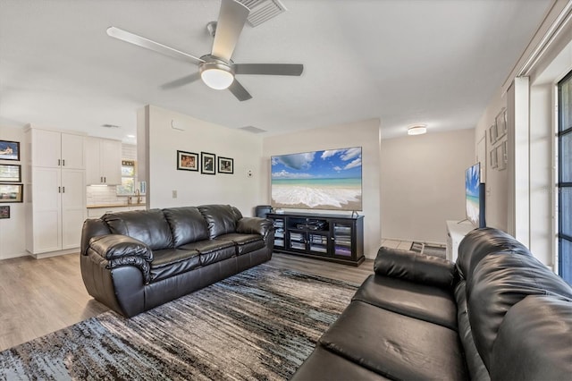 living room featuring ceiling fan and light wood-type flooring