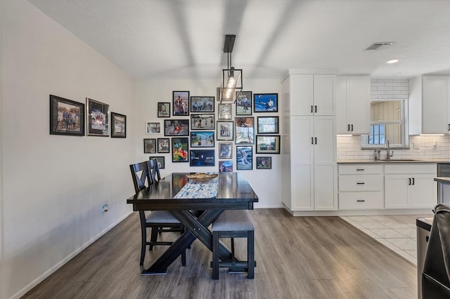 dining room featuring sink and light hardwood / wood-style flooring