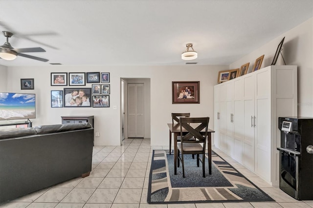 tiled dining space featuring ceiling fan