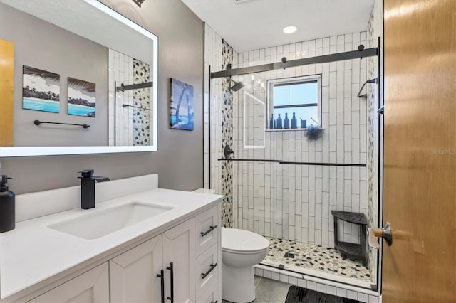 bathroom with vanity, an enclosed shower, and toilet