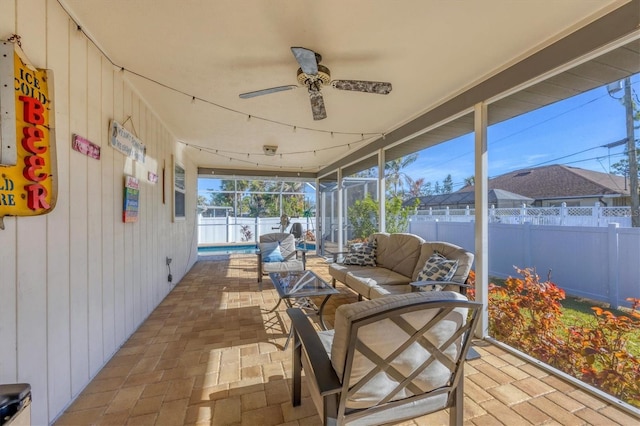 sunroom featuring ceiling fan