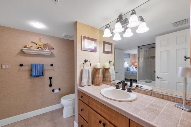 bathroom with vanity, tile patterned floors, and toilet