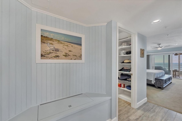 mudroom featuring ornamental molding, ceiling fan, and light wood-type flooring