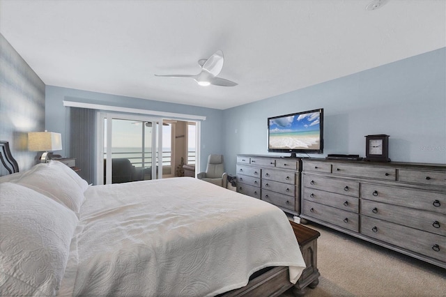 bedroom featuring access to outside, ceiling fan, and carpet