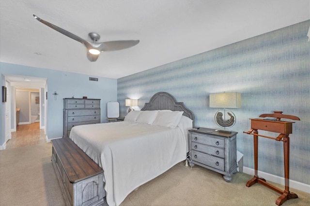 bedroom featuring light carpet and ceiling fan