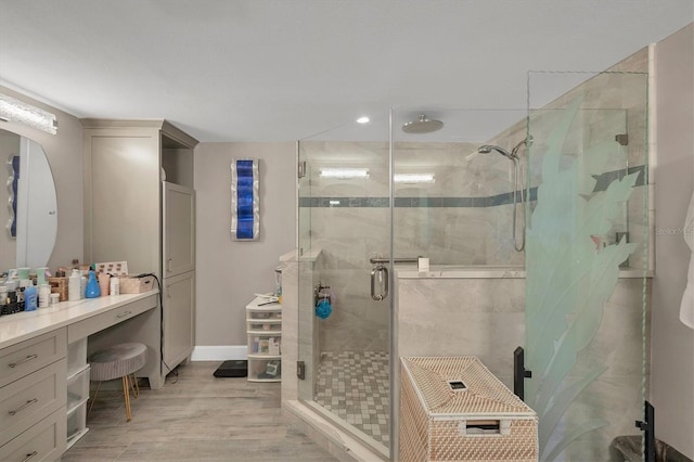 bathroom with vanity, hardwood / wood-style floors, and walk in shower