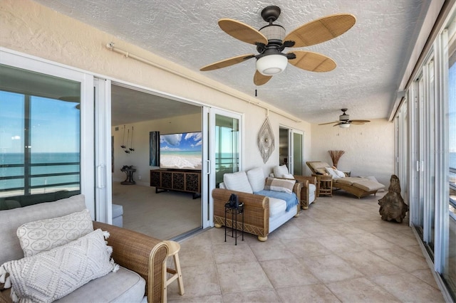 sunroom featuring ceiling fan