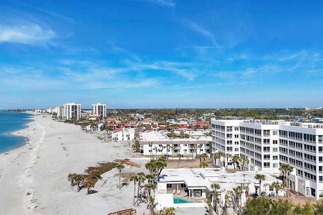 drone / aerial view with a water view and a beach view