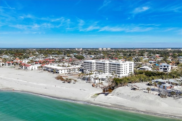 birds eye view of property featuring a water view and a beach view