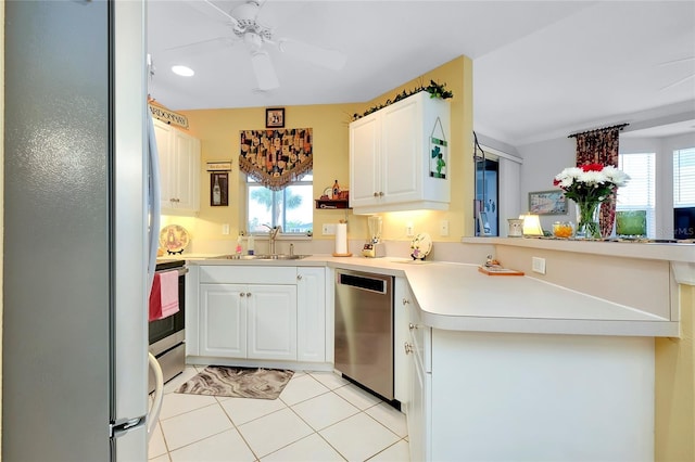 kitchen with stainless steel appliances, white cabinetry, sink, and a wealth of natural light