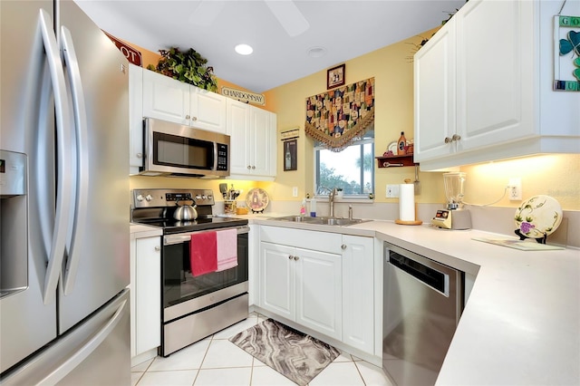 kitchen featuring appliances with stainless steel finishes, sink, and white cabinets