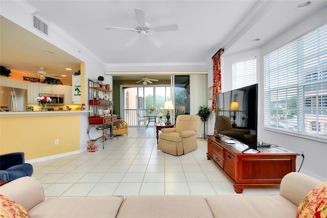 tiled living room with ceiling fan and ornamental molding