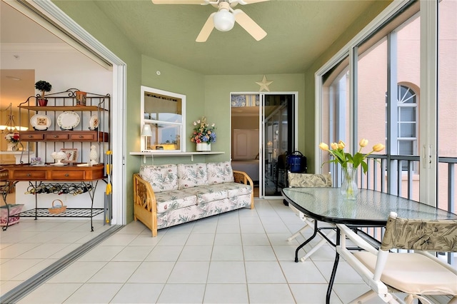 sunroom / solarium featuring ceiling fan