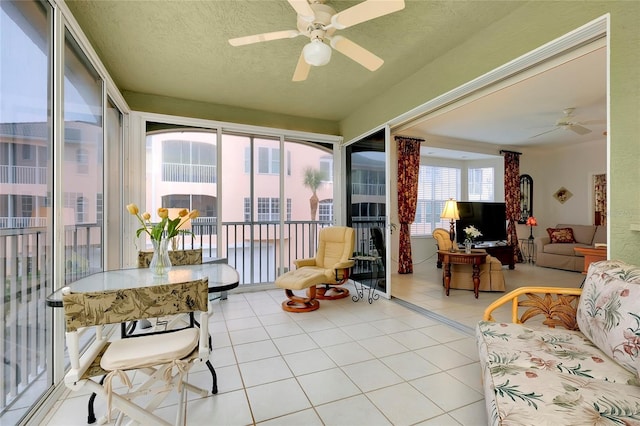 sunroom / solarium featuring ceiling fan