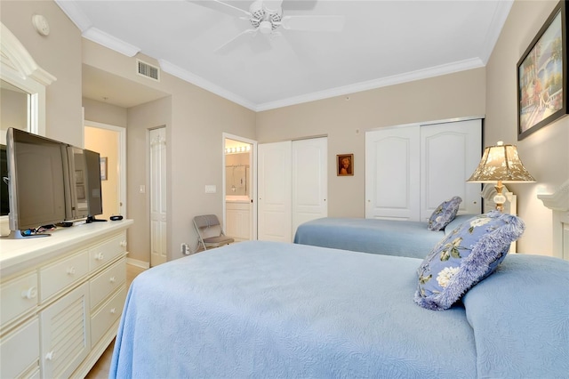 bedroom with two closets, ornamental molding, ceiling fan, and ensuite bathroom