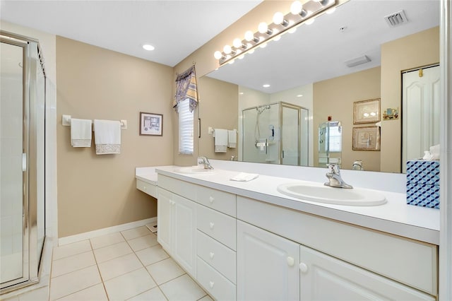 bathroom featuring vanity, an enclosed shower, and tile patterned flooring