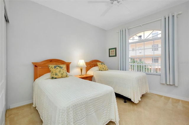 bedroom with light carpet and ceiling fan