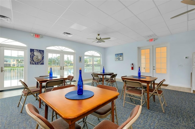 dining area featuring hardwood / wood-style flooring, a paneled ceiling, and french doors