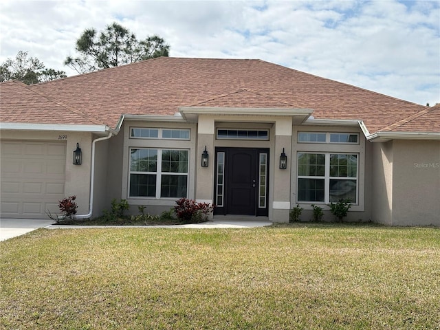 view of front facade with a garage and a front lawn