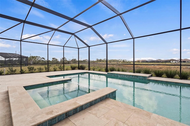 view of swimming pool featuring a lanai, a patio area, and an in ground hot tub