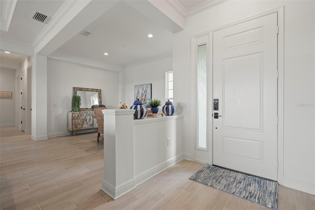 foyer featuring crown molding