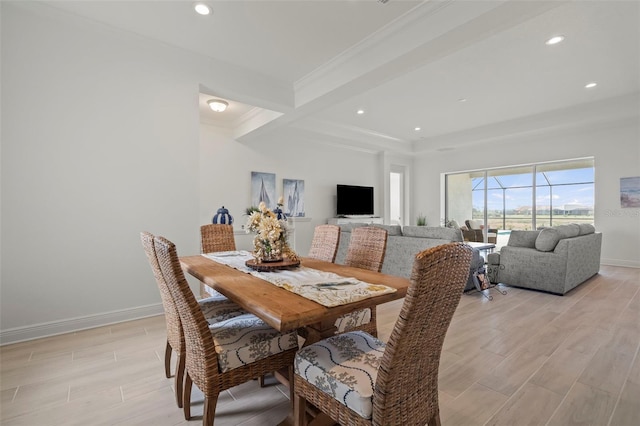 dining space featuring crown molding, light hardwood / wood-style flooring, and beamed ceiling