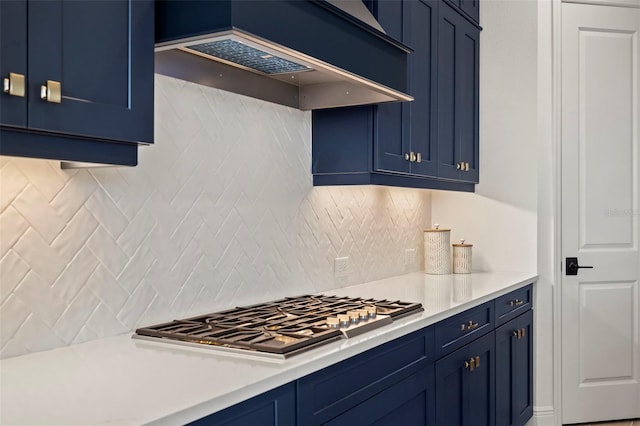 kitchen featuring custom exhaust hood, stainless steel gas stovetop, and blue cabinets