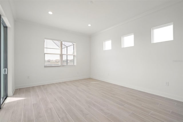 unfurnished room featuring ornamental molding and light wood-type flooring