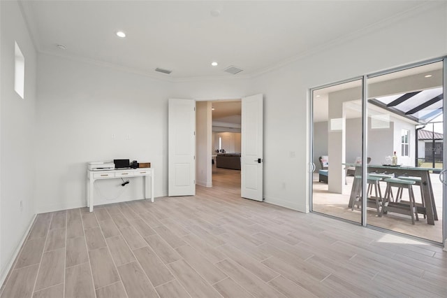 interior space with crown molding and light hardwood / wood-style floors