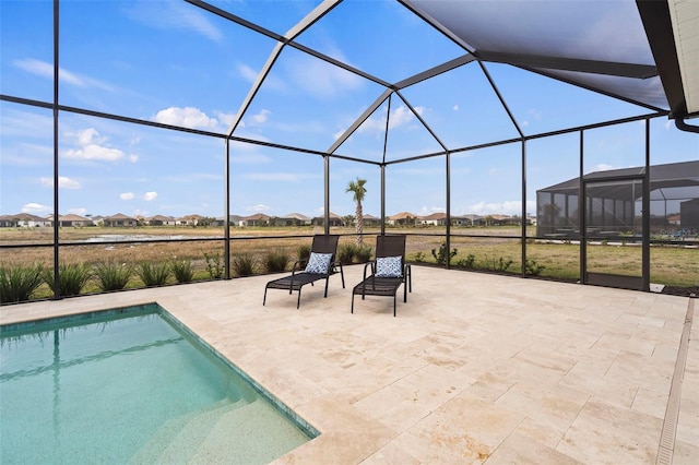 view of pool featuring a patio and glass enclosure