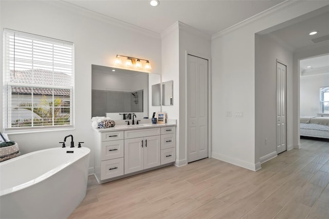 bathroom with wood-type flooring, shower with separate bathtub, vanity, and crown molding