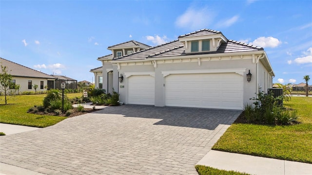 view of front of house with a garage and a front lawn