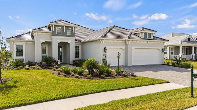 mediterranean / spanish home with a garage and a front yard