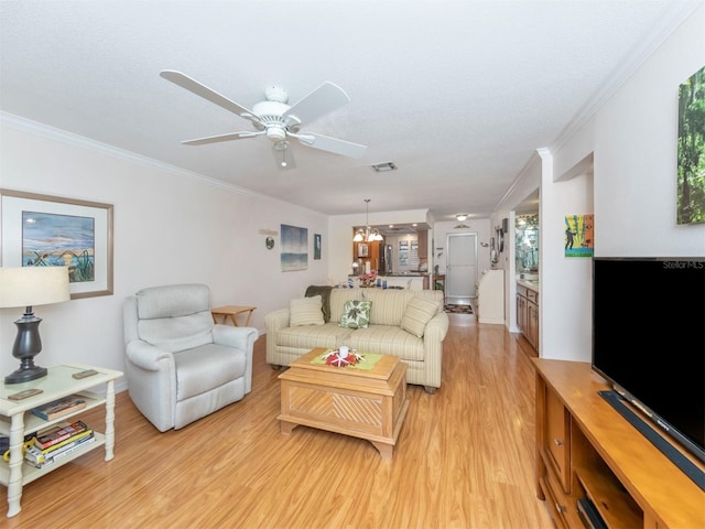 living room featuring crown molding, ceiling fan with notable chandelier, and light wood-type flooring