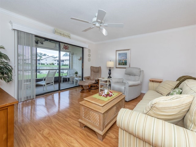 living room featuring crown molding, ceiling fan, and light wood-type flooring