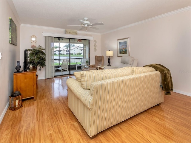 living room featuring crown molding, ceiling fan, and light wood-type flooring