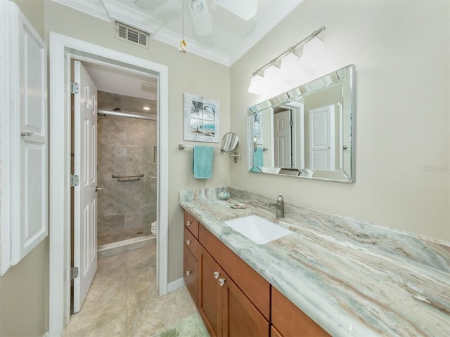 bathroom with an enclosed shower, vanity, ornamental molding, tile patterned floors, and toilet