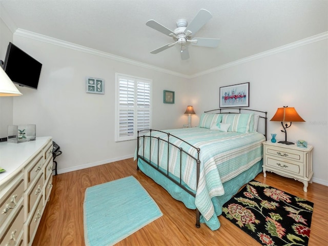 bedroom with ornamental molding, ceiling fan, and light hardwood / wood-style floors