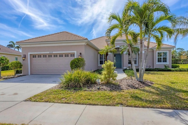 mediterranean / spanish house with a garage and a front lawn