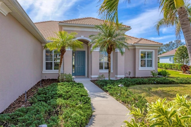 property entrance with a lawn