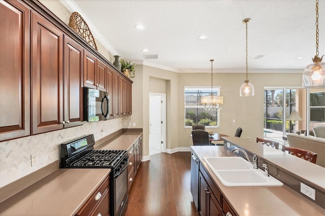 kitchen with ornamental molding, decorative light fixtures, sink, and black appliances