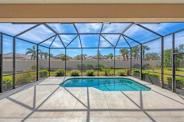 view of swimming pool featuring a patio and glass enclosure