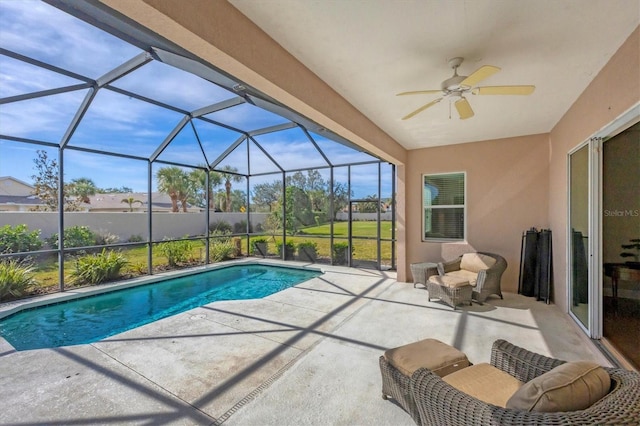 view of swimming pool featuring a lanai, a patio area, and ceiling fan