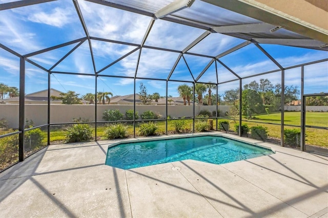 view of pool with a patio and glass enclosure