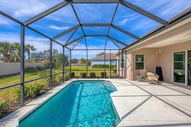 view of pool featuring a lanai, a patio area, and a lawn