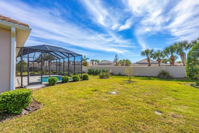 view of yard with a fenced in pool and glass enclosure