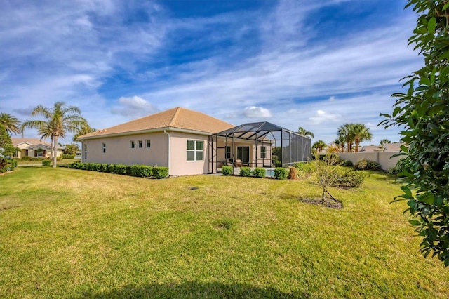 back of house featuring a lanai and a lawn