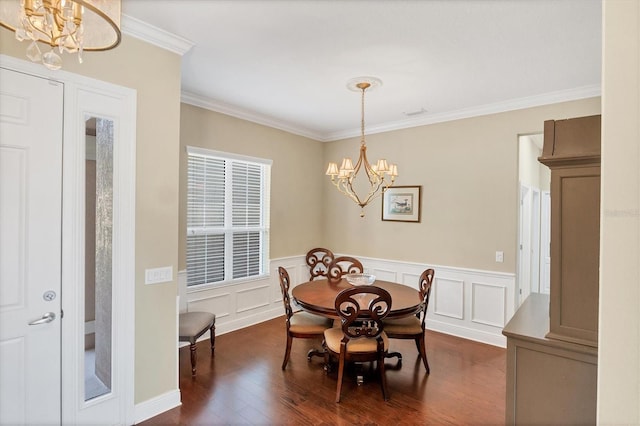 dining space featuring dark hardwood / wood-style flooring, a notable chandelier, and ornamental molding